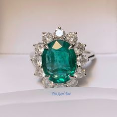 Absolutely stunning Zambian emerald 18k white gold ring! The emerald is from Zambia, beautiful rich green color and good clarity for its size. There are 1.77 carats of sparkly white diamonds adorning the ring! This ring comes with one certification: Gemological Institute of America (GIA) Ring Size: 7 Total Weight: 6.21 grams Precious Metal: 18k gold Precious stones: -Emerald Center Stone: 4.26 carats, 12.1mm x 9.5mm -White Diamonds: 1.77 carats Hallmark: 750 CS 4.26 D1.77 Luxury Green Diamond Ring In Platinum, Formal Green Platinum Diamond Ring, Green Oval Emerald Ring In Platinum, Dazzling Oval Emerald Ring In Platinum, Luxury Green Diamond Ring With Vvs Clarity, Luxury Green Diamond Ring With Brilliant Cut, Luxury Green Diamond Ring With Round Cut, Gia Certified Dazzling Emerald Ring With Diamond, Luxury Green Round Cut Diamond Ring