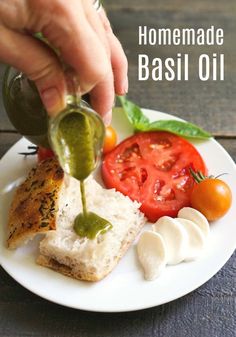 someone is pouring olive oil on bread with tomatoes, mozzarella and basil leaves