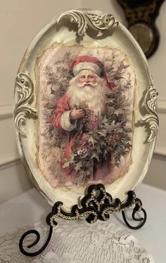 a plate with a santa clause on it sitting on top of a lace doily