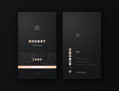 two black business cards with gold foil on the bottom and one has a logo that reads rocket