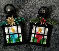 two christmas ornaments hanging from the side of a gray carpeted floor, each decorated with an ornament