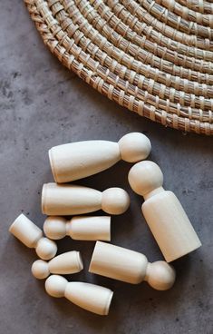 several wooden pegs sitting next to a woven basket