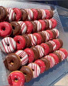 there are many donuts that have been decorated with red and white stripes on them