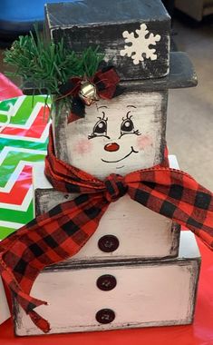 a snowman made out of wooden blocks on top of a table