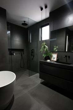 a modern bathroom with black and white decor