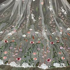 an embroidered veil with flowers on it