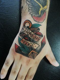 a man's hand with an anchor and lettering on it that says straight edge