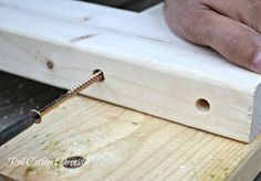 a person using a drill to cut wood