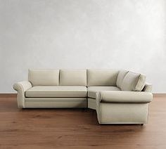 a white couch sitting on top of a hard wood floor