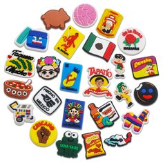 many different colored and shaped stickers on a white surface, including one with an image of cartoon characters