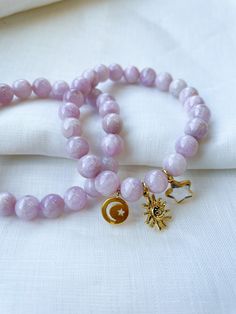 Soft purple kunzite beads make of this beautiful lavender beaded bracelet set with celestial charms. These bracelets are stretch bracelets and include star, moon and sun charms. Each piece is designed and handmade in Brooklyn. After visiting the Notre Maison orphanage in 2015, I fell in love with the children and knew I wanted to help sponsor them. That's what started this shop. Every purchase helps us sponsor 5 children at the orphanage that we follow up with and visit over the summers. Join ou Celestial Style Adjustable Beaded Bracelets With Round Beads, Adjustable Celestial Beaded Bracelets With Round Beads, Adjustable Beaded Bracelets With Moon Charm, Adjustable Spiritual Beaded Bracelet With Moon Charm, Celestial Style Beaded Bracelets As Gift, Handmade Celestial Beaded Bracelets With Round Beads, Beaded Bracelets With Star Charm For Gifts, Handmade Celestial Beaded Bracelets For Gifts, Lavender Beaded Bracelet