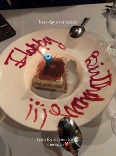 a piece of cake on a white plate with the words happy birthday written on it