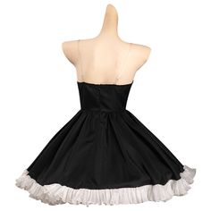 a black dress with white ruffles on the bottom and straps at the waist