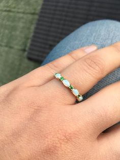 Opal and Emerald Half Eternity Matching Band Ring. Material: Solid Gold or PLATINUM Finishing: High Polished, Shiny Fit: Standard Width: 3.2 mm Height: 3 mm Setting: Prong Stone #1: Natural Opal Shape: Oval Size: 3mm x 5mm Quantity: 5 Opals Stone #2: Natural Emerald Quality: AAA Cut: Round, Diamond Cut Size: 2mm Quantity: 4 Emeralds This band will turn your Engagement Solitaire into a Sophisticated Wedding Set (Bridal Set). It will make your Solitaire Ring to pop out and look more eye catchy and Wedding Ring Opal, Unique Opal Ring, Opal Wedding Ring, Opal Stacking Ring, Pave Wedding Bands, Unique Opal, Opal Wedding, Opal Band, Opal Wedding Rings