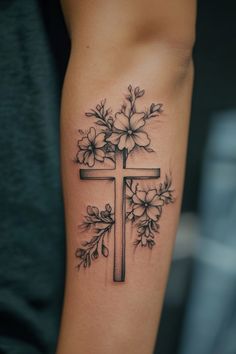 Cross tattoo adorned with flowers on forearm. Feminine Bible Verse Tattoos, Bible Verse Inspired Tattoo, Cute God Tattoos For Women, Flower Tattoos With Cross, Tattoos For Mentality, Faithful Tattoo Ideas, Cute Bible Verse Tattoos For Women, Small Tattoos For Moms With Sons, Christian Tattoos For Women Forearm