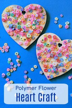 two heart shaped buttons sitting on top of a blue surface with the words polymer flower heart craft