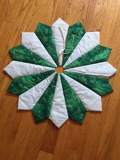 a green and white piece of cloth on top of a wooden floor