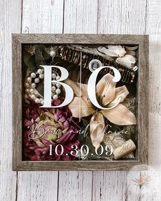 a wooden frame with flowers and pearls in it that says, bq because we are married