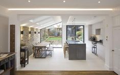 an open kitchen and dining room with white walls