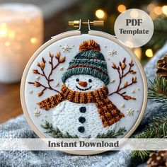 a snowman with a hat and scarf is shown in this embroidery pattern