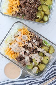 two plastic containers filled with meat, cheese and olives on top of a table