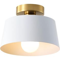 a white and gold ceiling light with a round shade on the bottom half of it