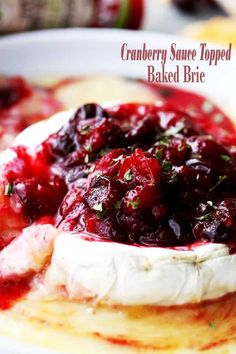 cranberry sauce topped baked brie on top of pancakes in a white bowl