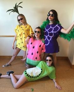 four women dressed in costumes posing for the camera