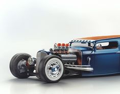 an old fashioned hot rod car is shown in this image