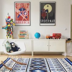 a child's room with toys and posters on the wall