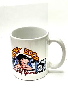 a white coffee mug with an image of a boy on it