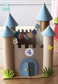 a castle made out of cardboard sitting on top of a wooden floor