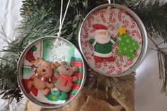 two ornaments hanging from a christmas tree in front of a bag with decorations on it