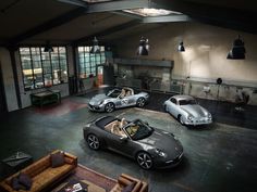 three sports cars are parked in a garage