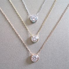 "Our solitaire cubic zirconia necklace is delicate and dainty. The cubic zirconia stone is framed and attached at separate points to the chain, the cz is stationary. Available in sterling silver, 14tk gold filled & rose gold filled. DETAILS & SIZE *The listing is for the solitaire necklace *Available in our high quality 14K gold filled, rose gold filled or sterling silver chain and findings. *Cubic zirconia: 9 mm *Every purchase comes in a Tangerine branded gift box. *Handcrafted with ca Round Cut Solitaire Necklace With Delicate Chain, Classic Solitaire Necklace With Delicate Chain And Cubic Zirconia, Anniversary Cubic Zirconia Solitaire Necklace With Delicate Chain, Diamond White Cubic Zirconia Solitaire Necklace With Delicate Chain, Delicate Cubic Zirconia Solitaire Necklace With Clavicle Chain, Delicate Cubic Zirconia Necklace With Bezel Setting, Fine Jewelry Solitaire Necklace With Delicate Chain, Diamond White Solitaire Necklace With Adjustable Chain, Formal Solitaire Necklace With Delicate Cubic Zirconia Chain