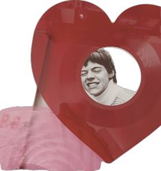 a red heart shaped object with a man's face in the center