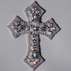 the cross is adorned with crystal stones