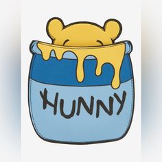 a cartoon bear sticking out of a blue container with yellow liquid on it's side