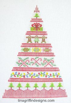 a cross stitch christmas tree with presents on it