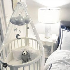 a baby crib with a teddy bear in it and an instagram post about the baby's birth