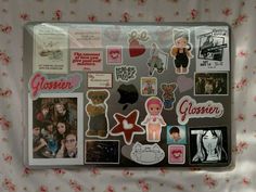 a laptop covered in stickers and pictures