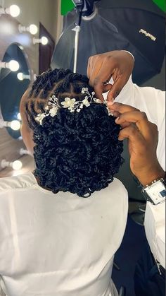 a woman getting her hair done in front of a mirror