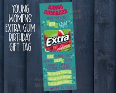 an extra birthday gift tag is hanging on a wooden fence with the words extra written across it