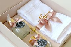 the personalized towels and bath mitts are packaged in a gift box with ribbon