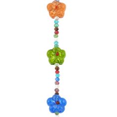 a multicolored glass beaded necklace with hearts and flowers hanging from it's side