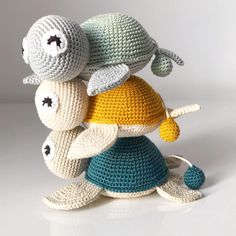 three crocheted stuffed animals sitting next to each other