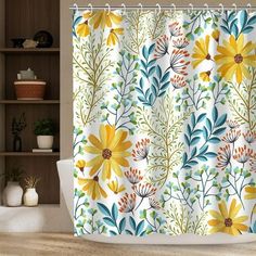 a shower curtain with yellow flowers and leaves on it in a bathroom next to a toilet