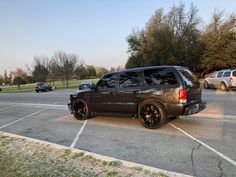 a black suv parked in a parking lot