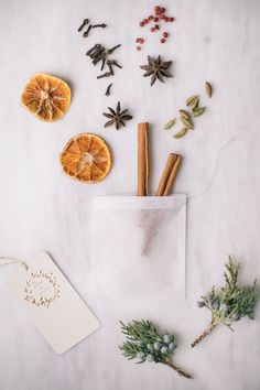 an assortment of spices and herbs in a bag on a white surface with a tag