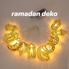 the word ramadaan deko is lit up with string lights and some strings